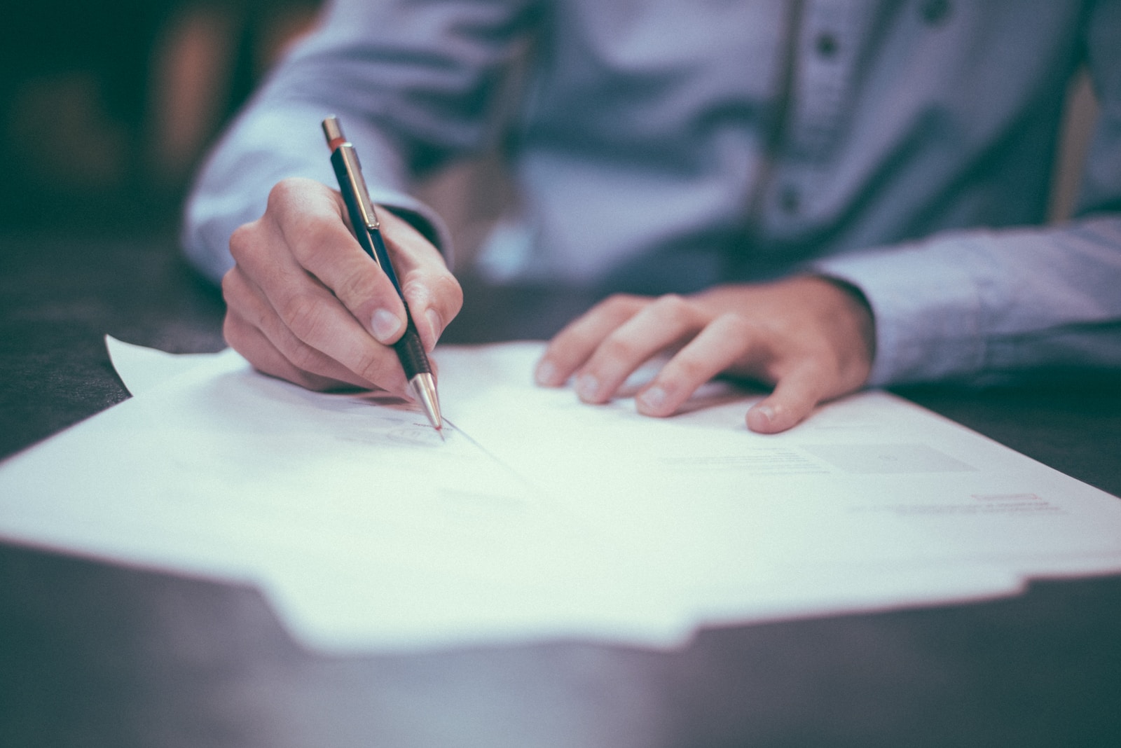 man signing business insurance papers